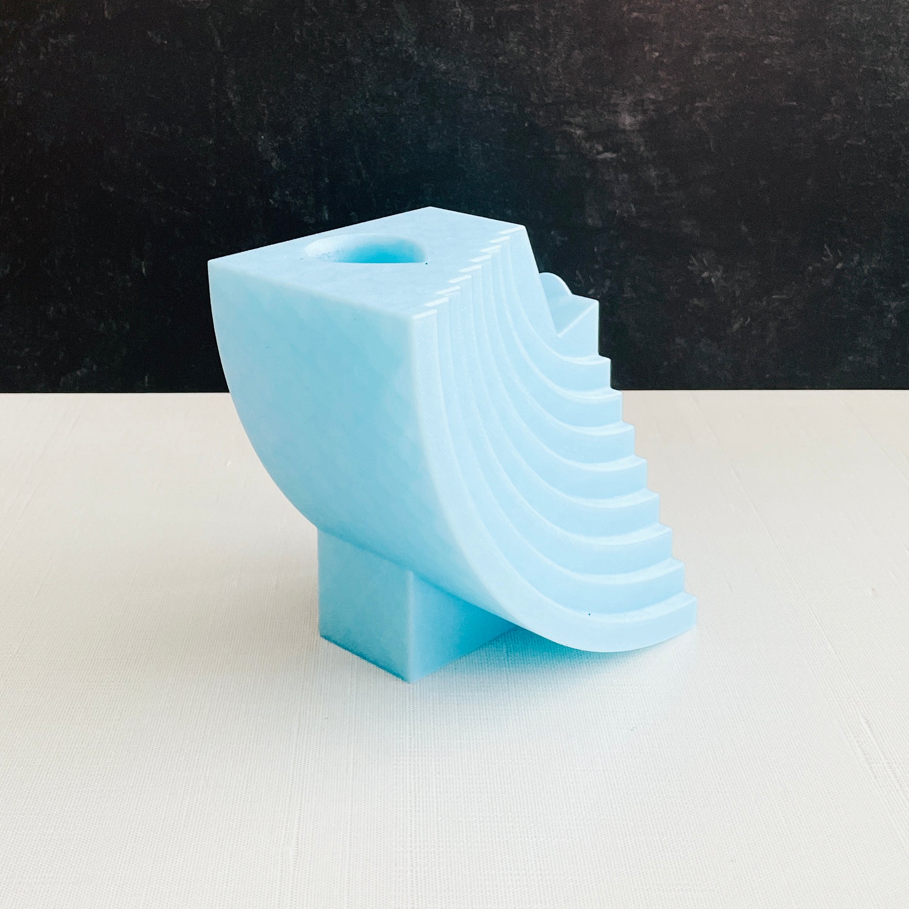 3D printed crescent moon-style controller stand with hole for succulent