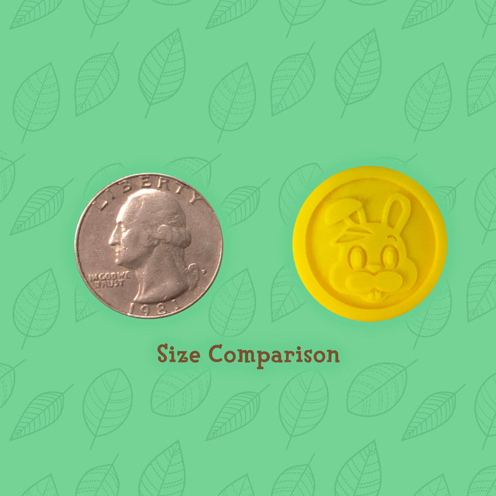 3d printed adventure coin with bunny icon and quarter for size comparison