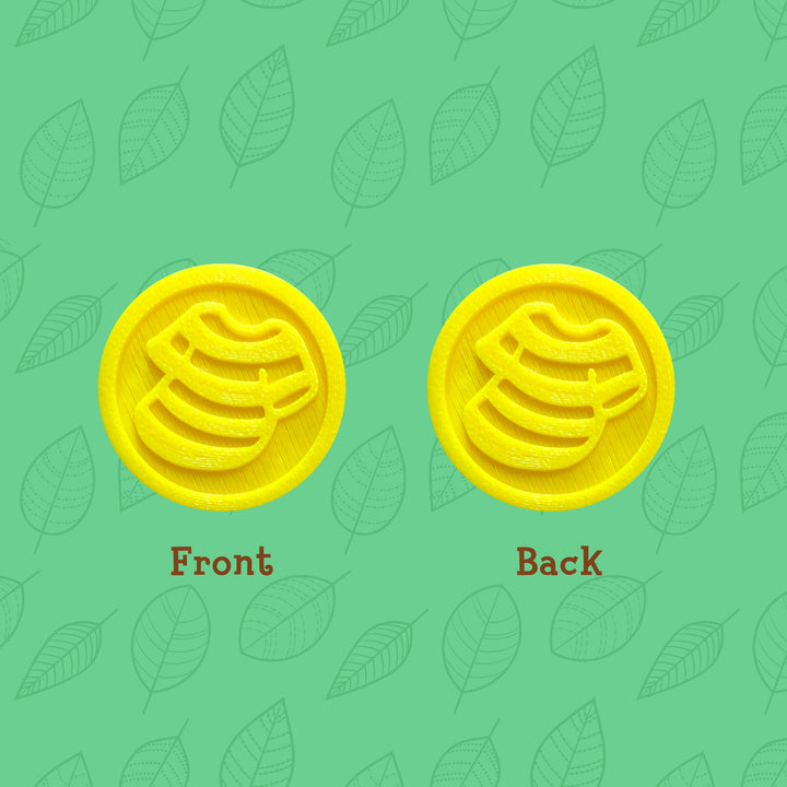 3d printed yellow coins with shirt icon on both sides