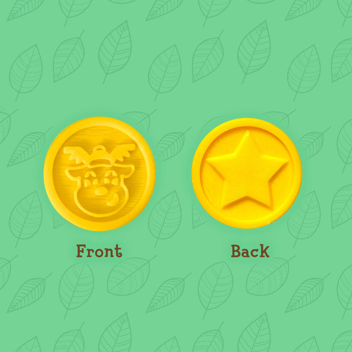 3D printed yellow adventure coins with images of a reindeer and star on them