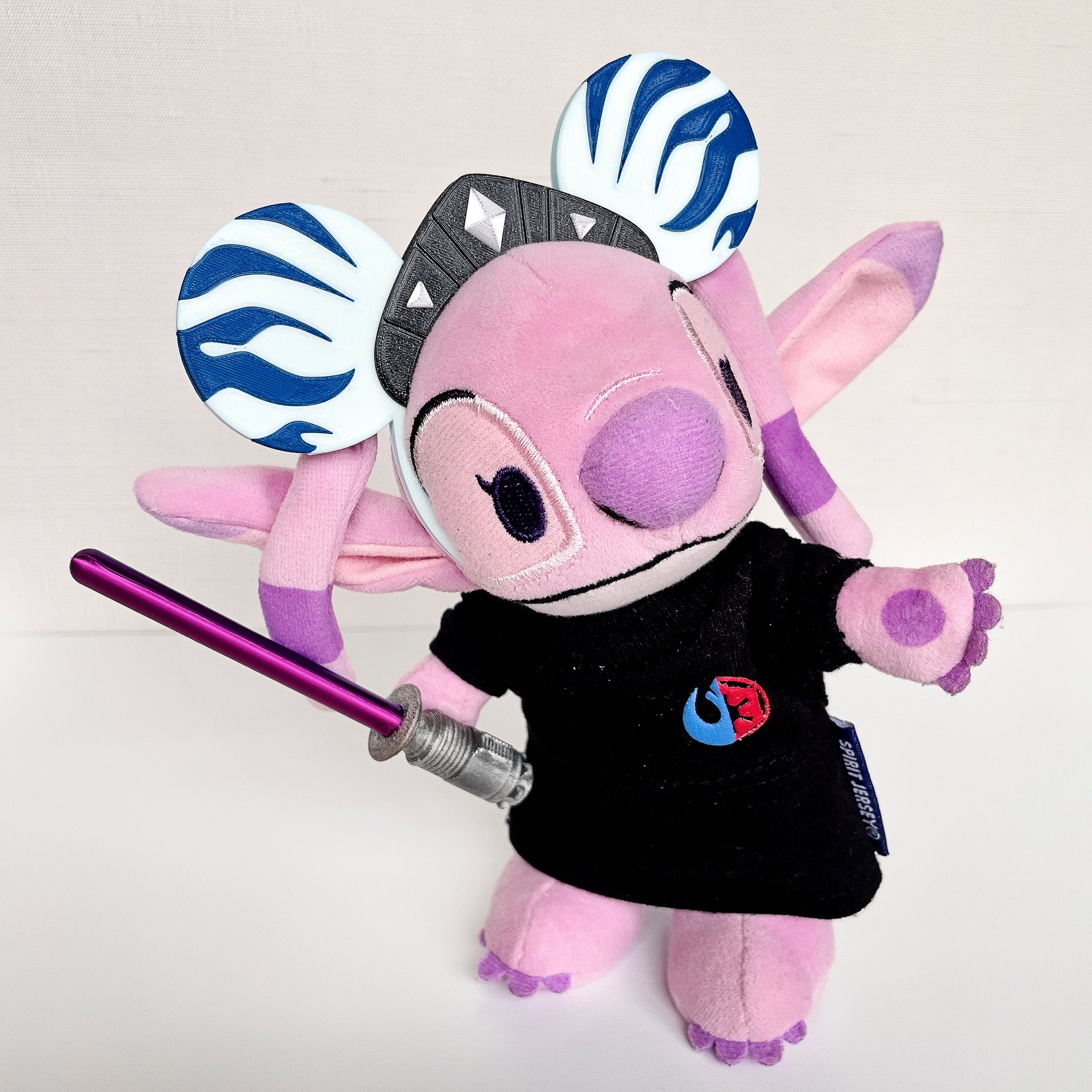 Pink plush toy with White Ears and Gray Crown on a white background