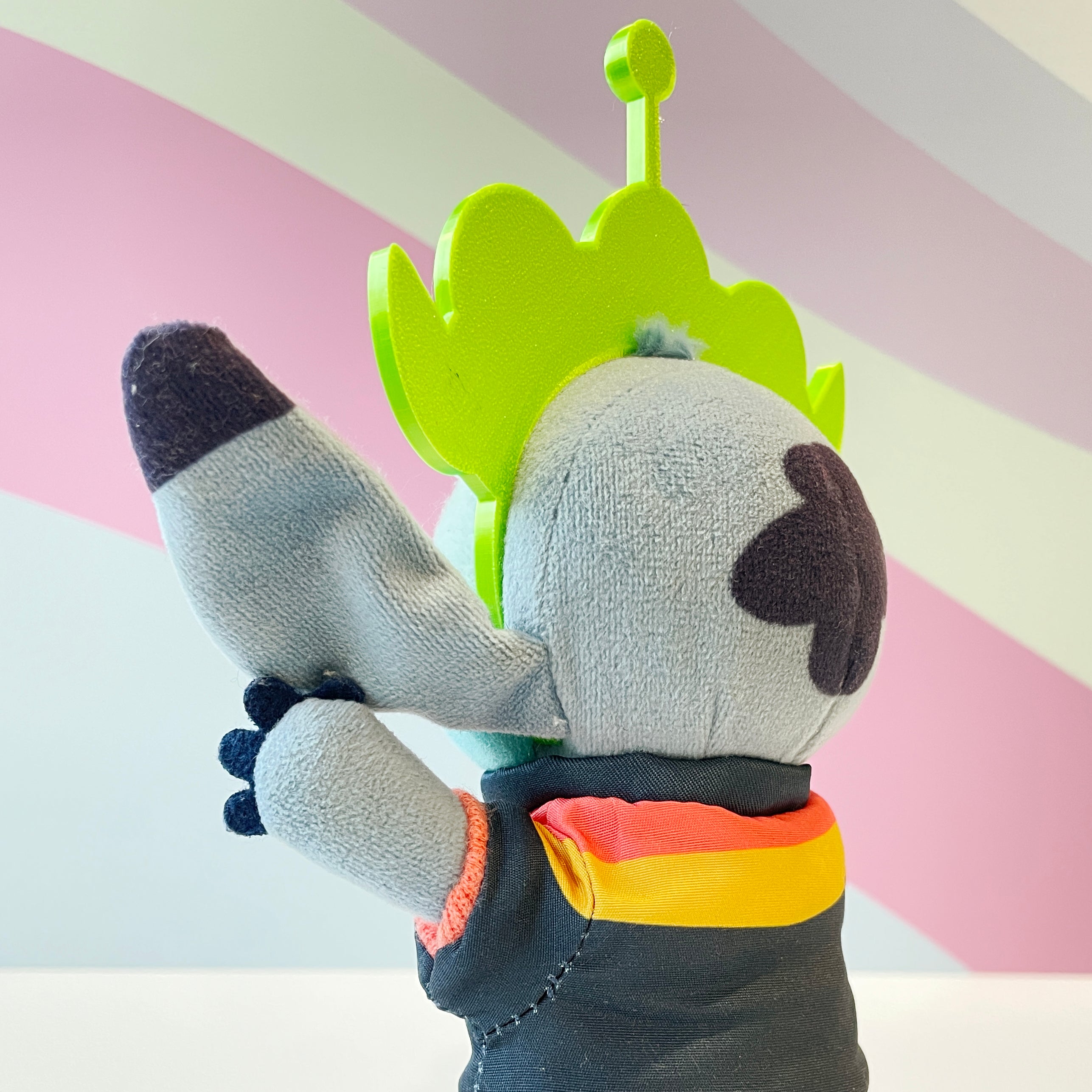 Lime Green Alien Headband on a blue plush on a pastel background