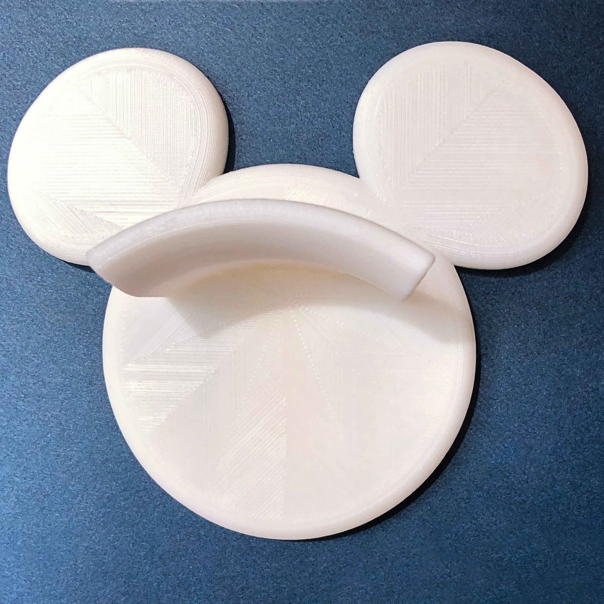 White Modern organizer hook for headbands and hats on blue background