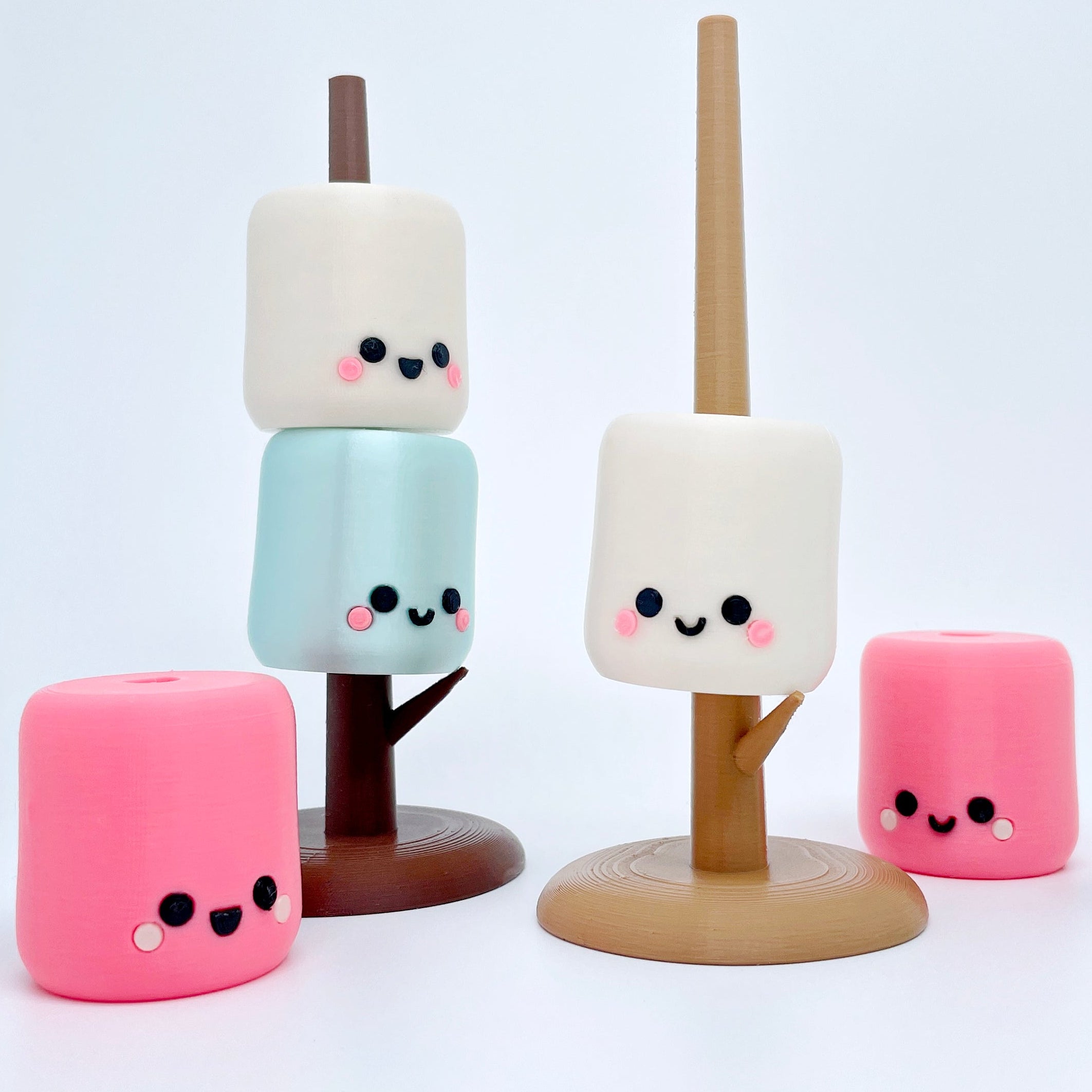 Colorful marshmallow-shaped characters with cute face designs on a white background