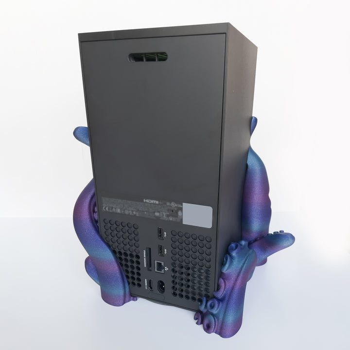 Two-part tentacle dock holding a vertical gaming console on white background
