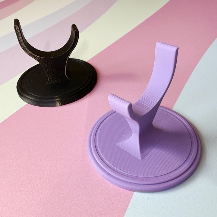 Light Purple and Black Display Stand on colorful background.