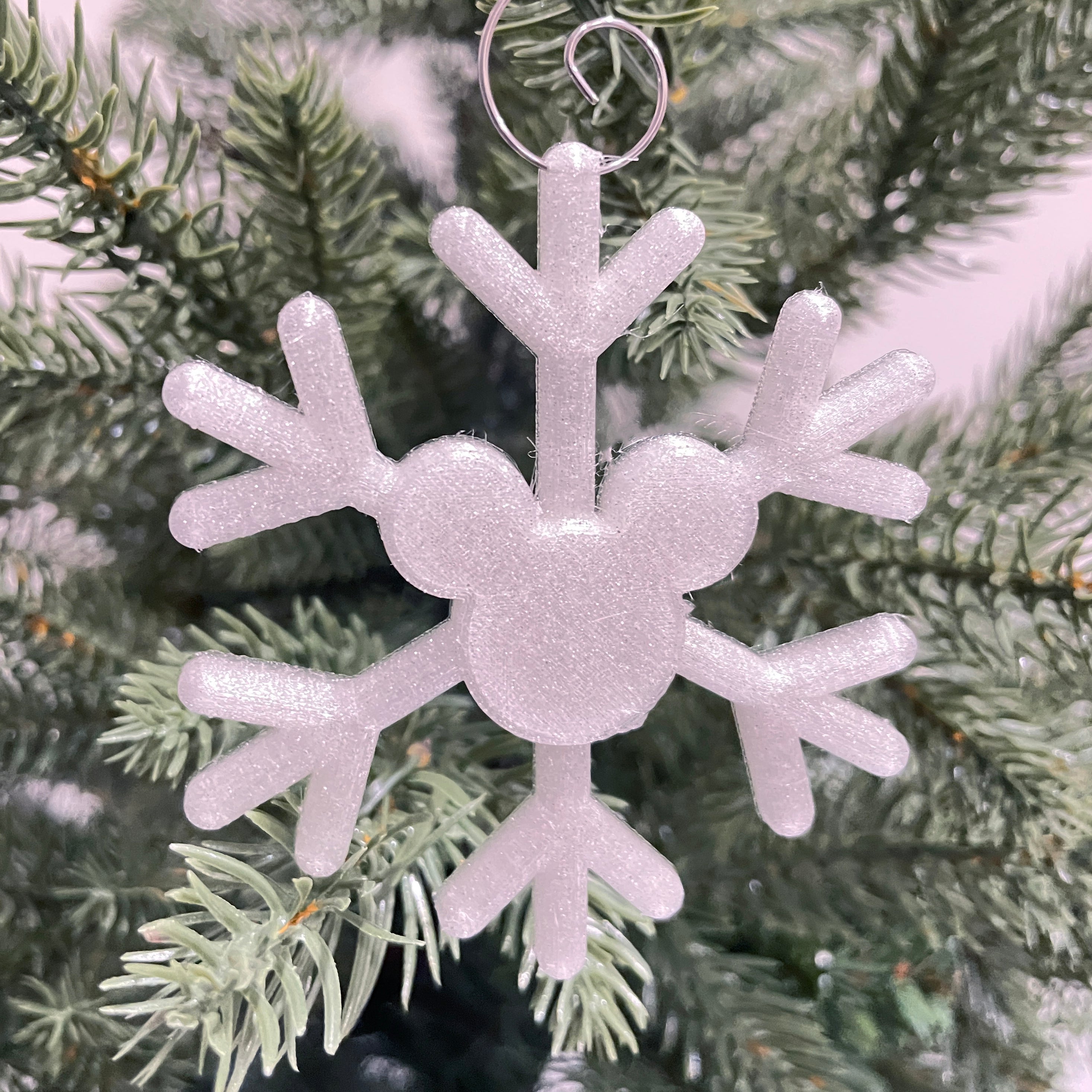 Glitter Snowflake-shaped ornament on a Christmas tree