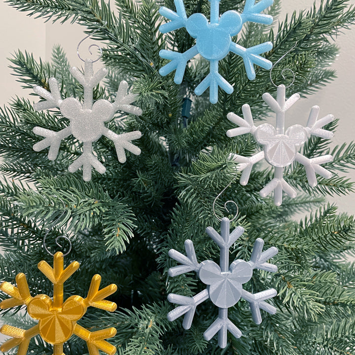 Colorful snowflake-shaped ornaments on a Christmas tree.