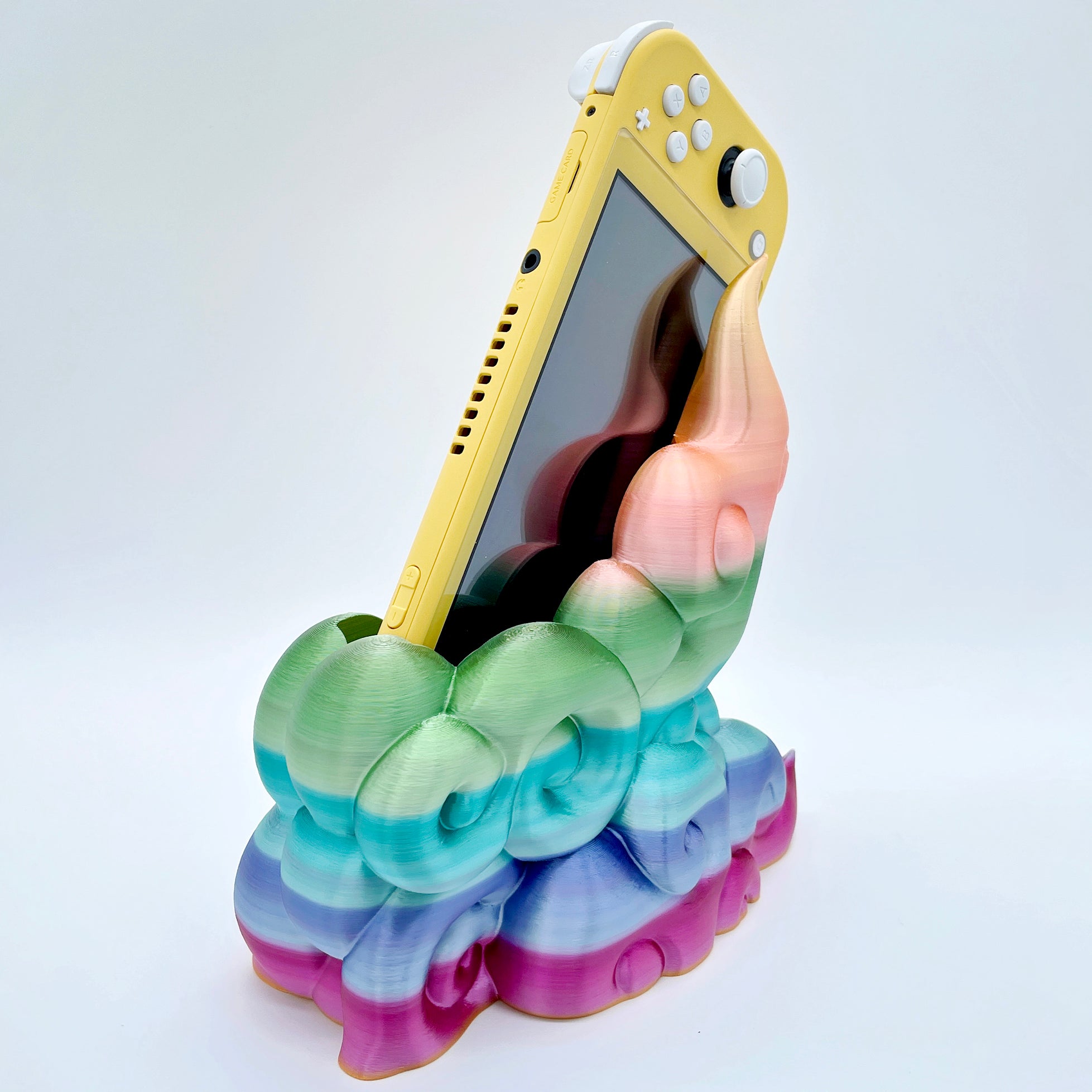 Rainbow gradient 3D printed cloud-style dock for compact handheld console on white background