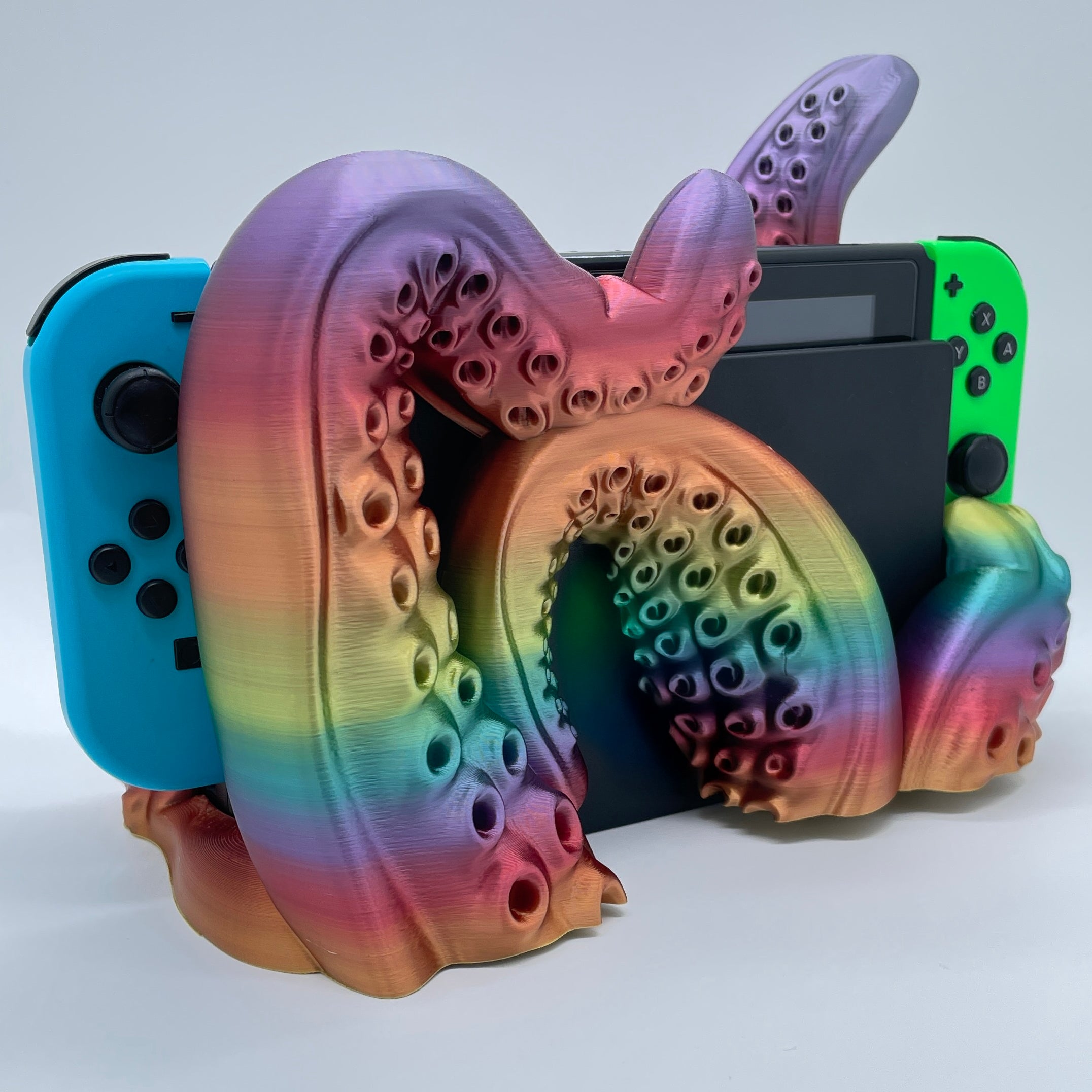 Rainbow Tentacle 3D printed dock sized for handheld gaming console on white background