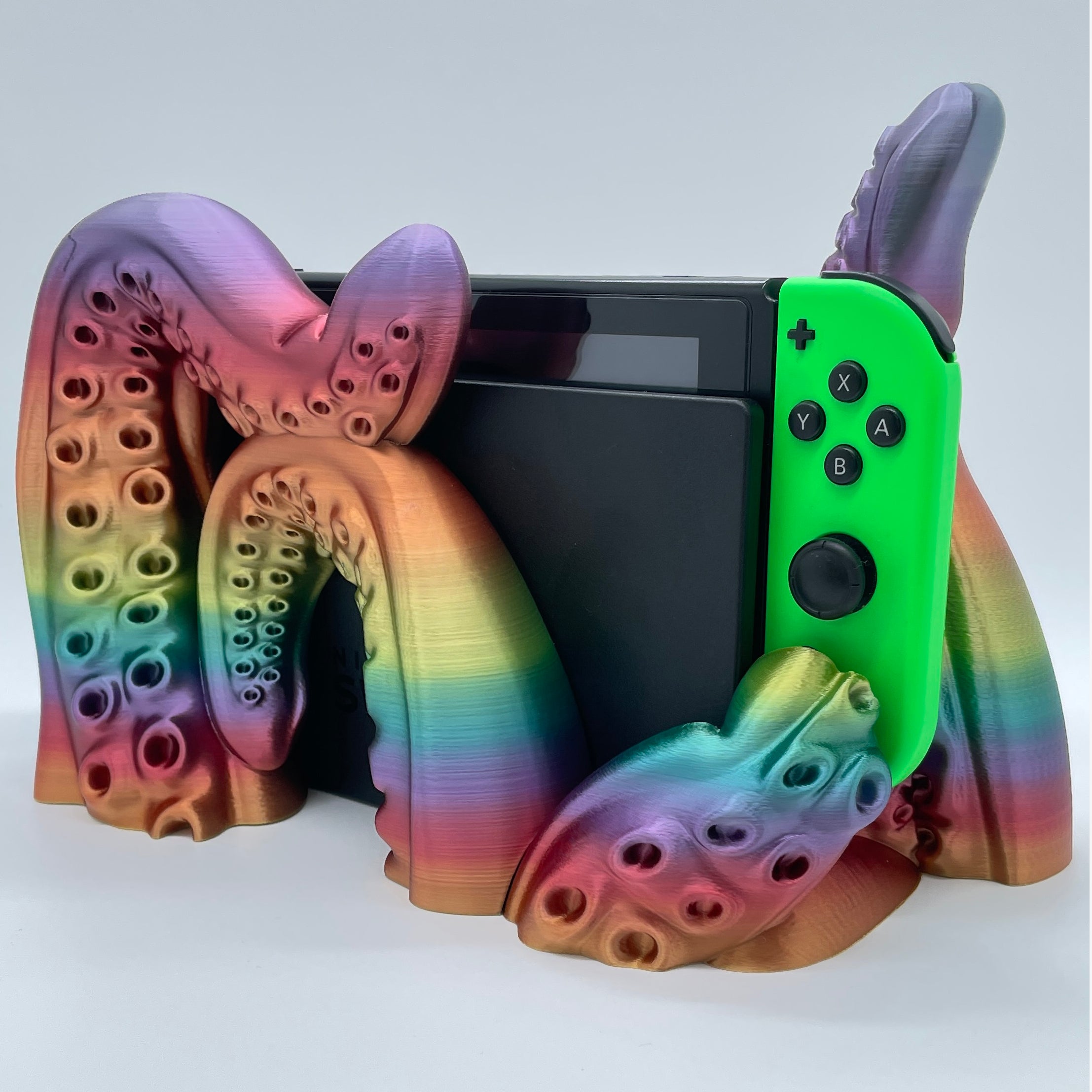 Rainbow Tentacle 3D printed dock sized for handheld gaming console on white background