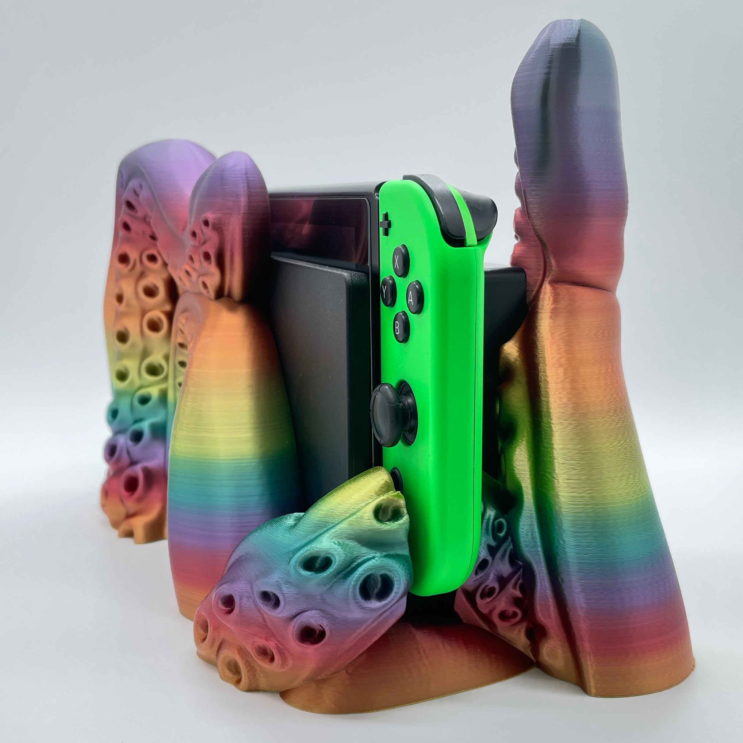 Rainbow Tentacle 3D printed dock sized for handheld gaming console on white background