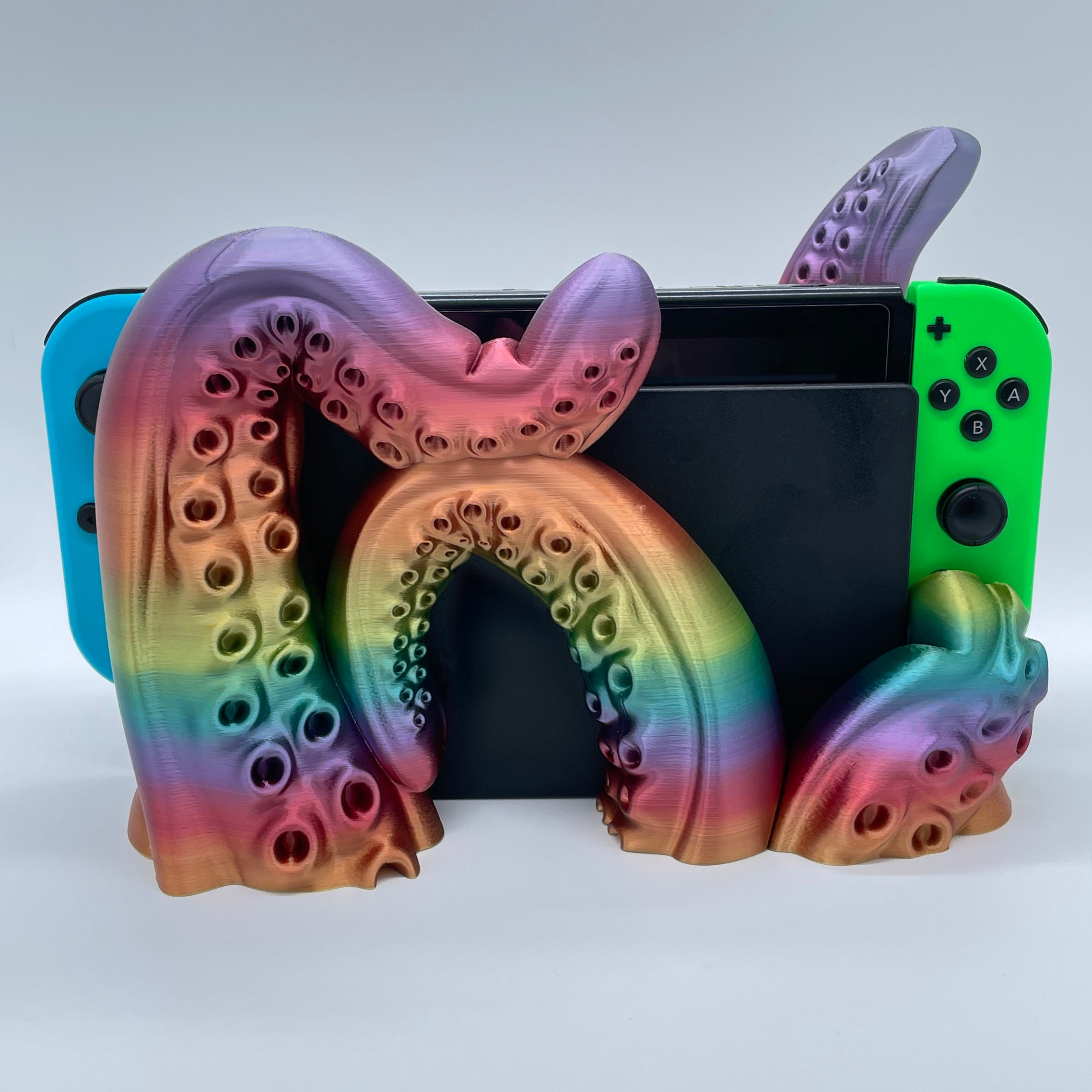 Rainbow Tentacle 3D printed dock sized for handheld gaming console on white background