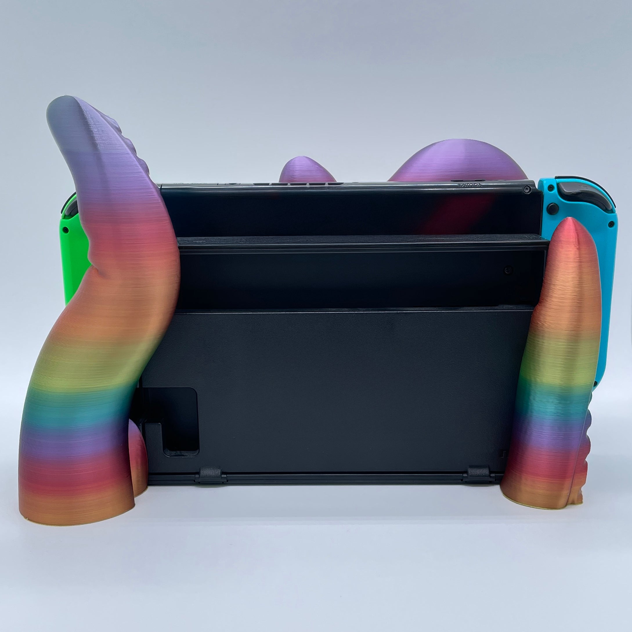 Rainbow Tentacle 3D printed dock sized for handheld gaming console on white background