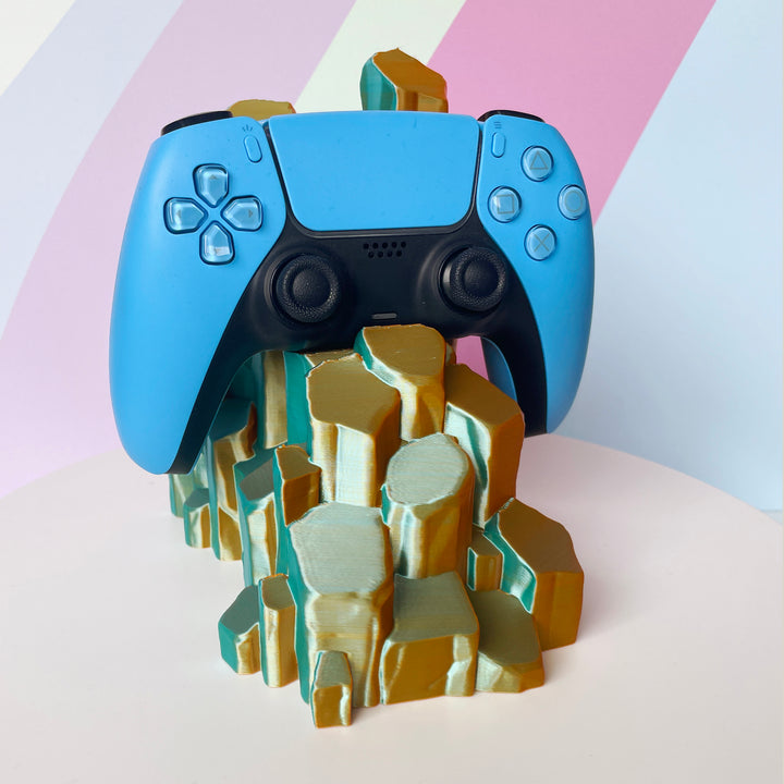 Blue gaming controller on sun-kissed quartz 3D printed controller stand on white background against a colorful background