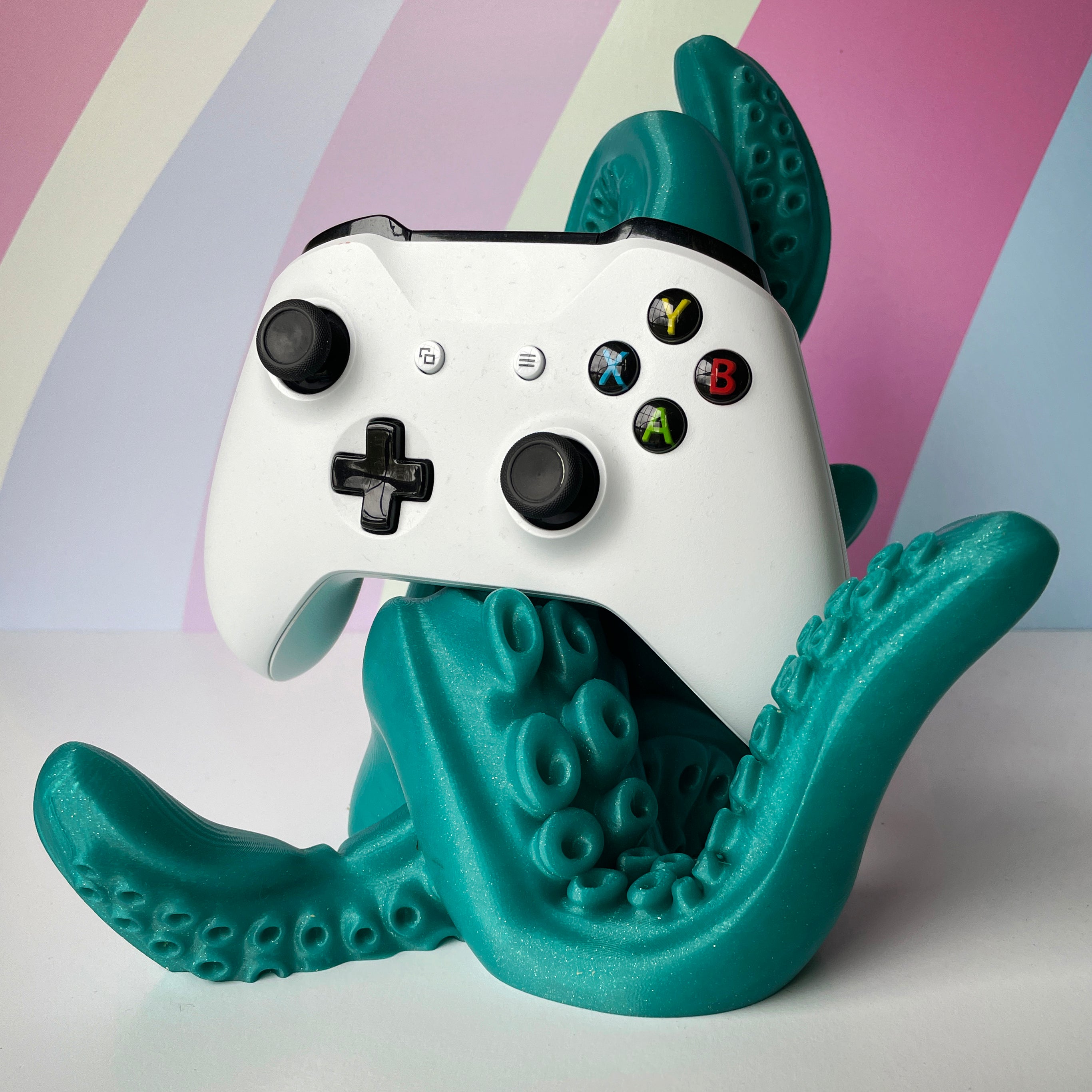 White Gaming Controller on Mermaids Tale Green 3D printed tentacle-style controller stand on colorful background