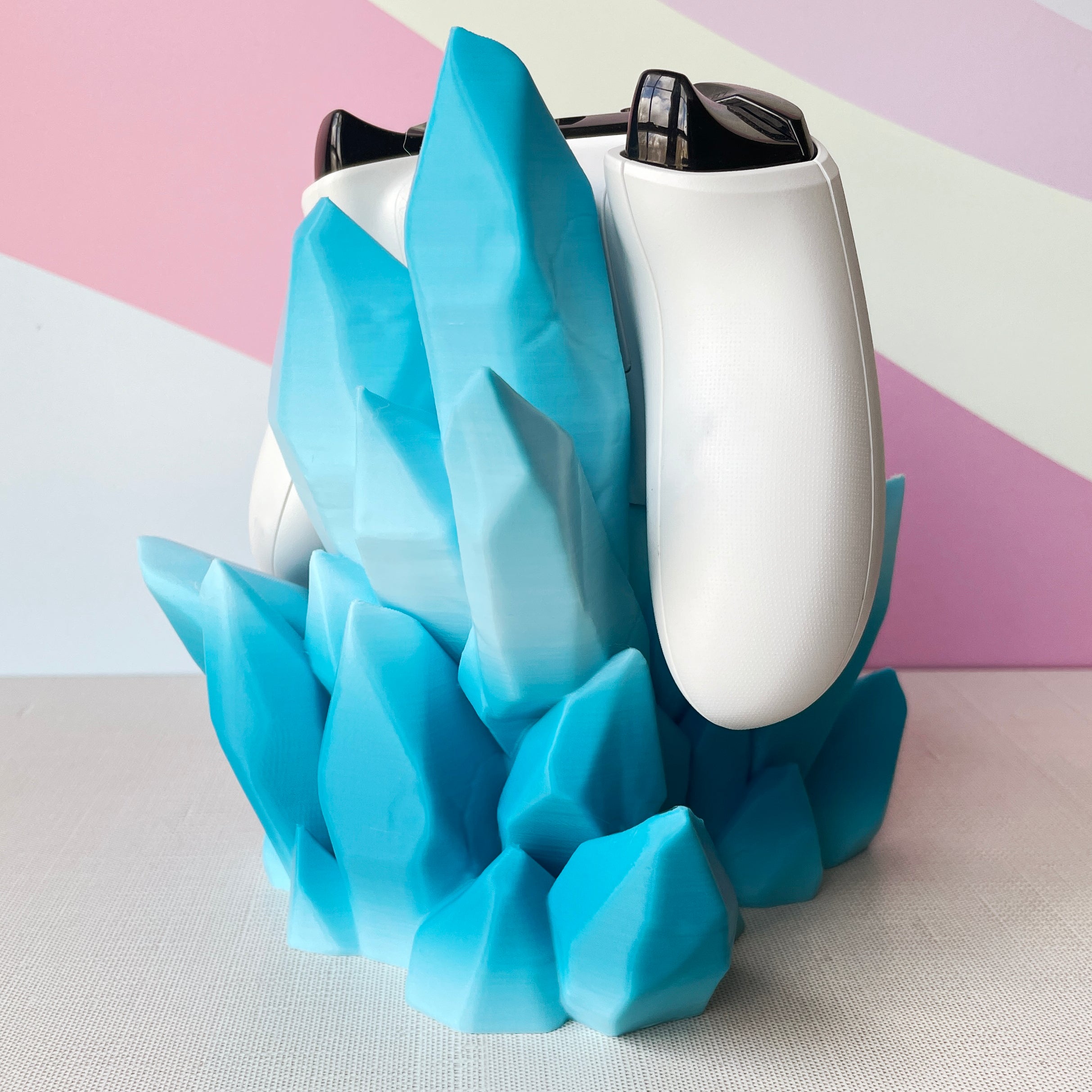 White electronic device with blue geometric base on a light background