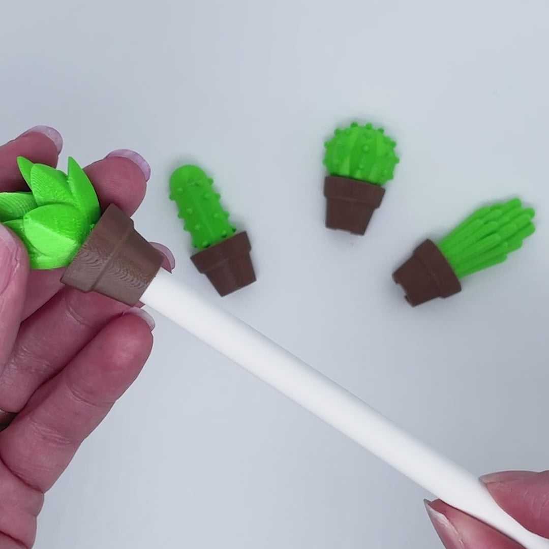 Set of four small 3D printed succulent clips for stylus or pen on white background