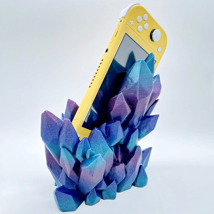Blue-purple-pink 3D printed crystal-style dock with Yellow compact handheld console on white background