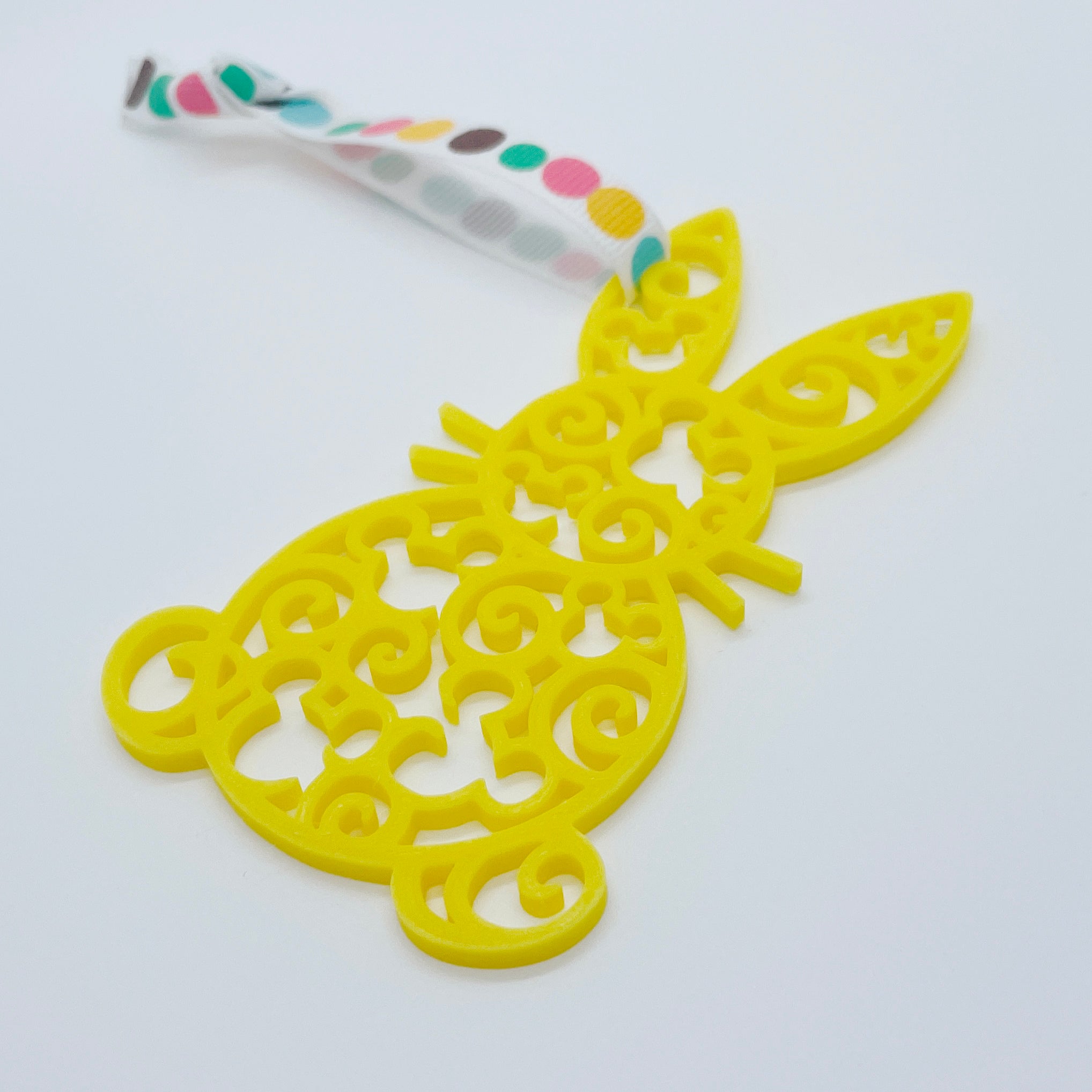 Filigree bunny-shaped Easter tags in bright yellow, 3D printed design.